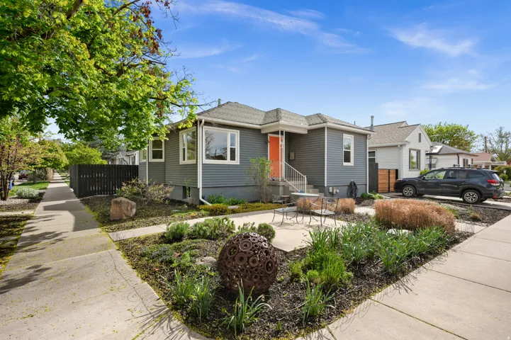 Charcoal gray siding exterior with white trim, professional xeriscaping