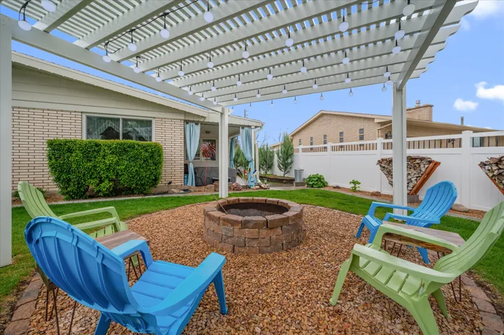 Fenced backyard featuring a pergola, a patio, and an outdoor fire pit