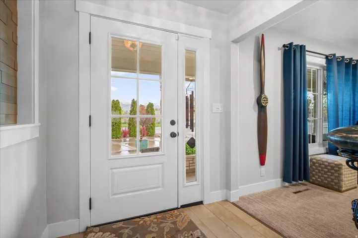 Foyer entrance with baseboards and wood finished floors