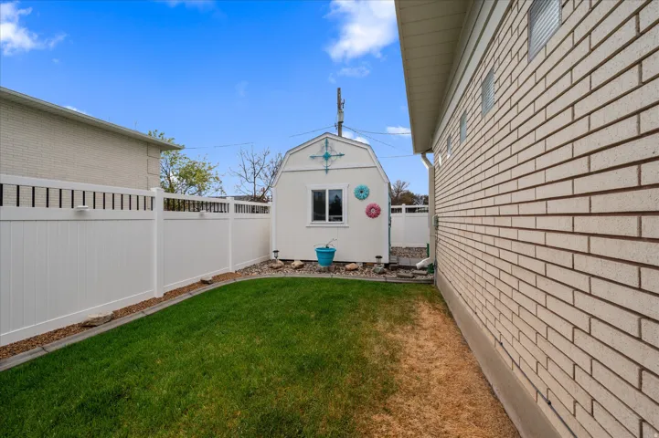 Fenced backyard with an outdoor structure