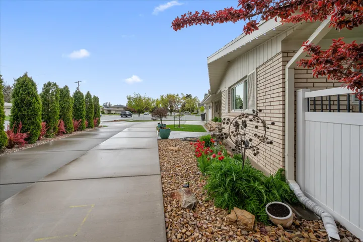 View of side of home featuring brick siding and a residential view