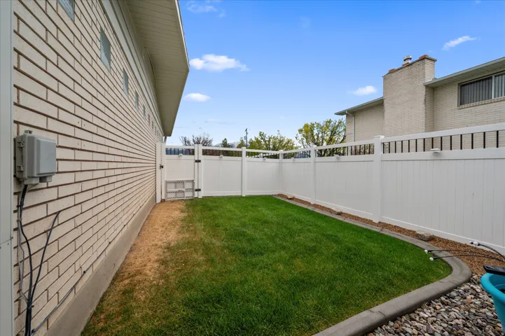 Fenced backyard featuring a gate