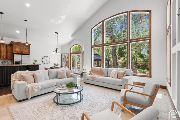 Great room featuring a vaulted ceiling and a large arched window wall