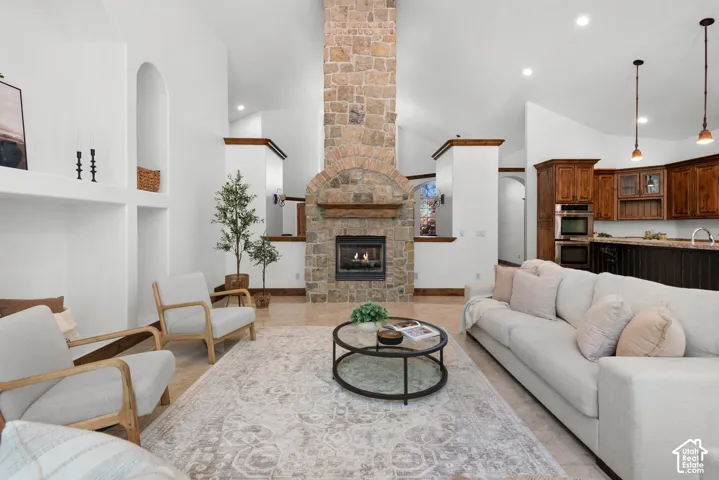 Stone-clad fireplace with arched detailing and wood mantel
