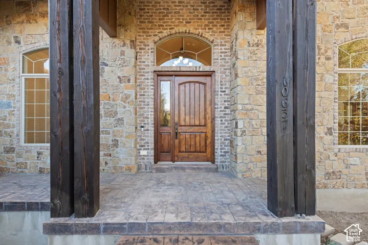 Doorway to property featuring brick siding