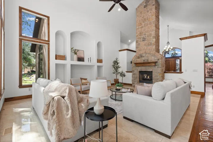 Vaulted ceilings accentuating a stone fireplace with a wood mantle and hearth