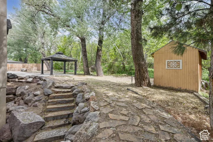View of patio featuring a gazebo and an outdoor structure