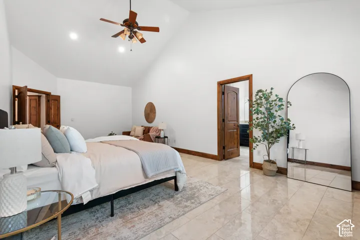 Spacious room featuring vaulted ceilings, recessed lighting, a ceiling fan, and tile flooring
