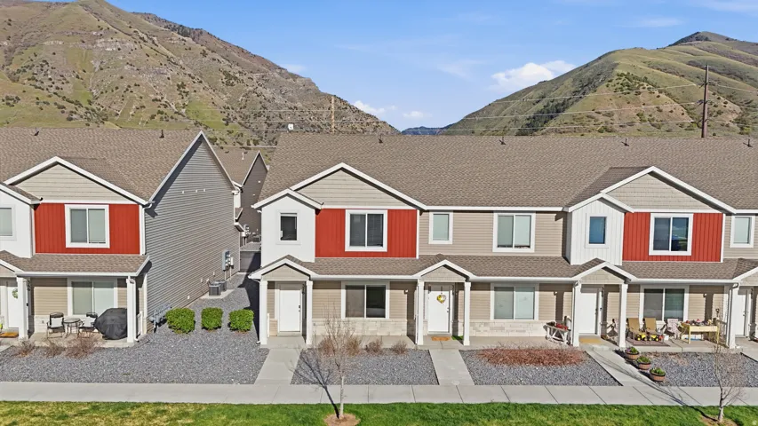 View of front of property featuring a mountain view, covered porch, and a shingled roof