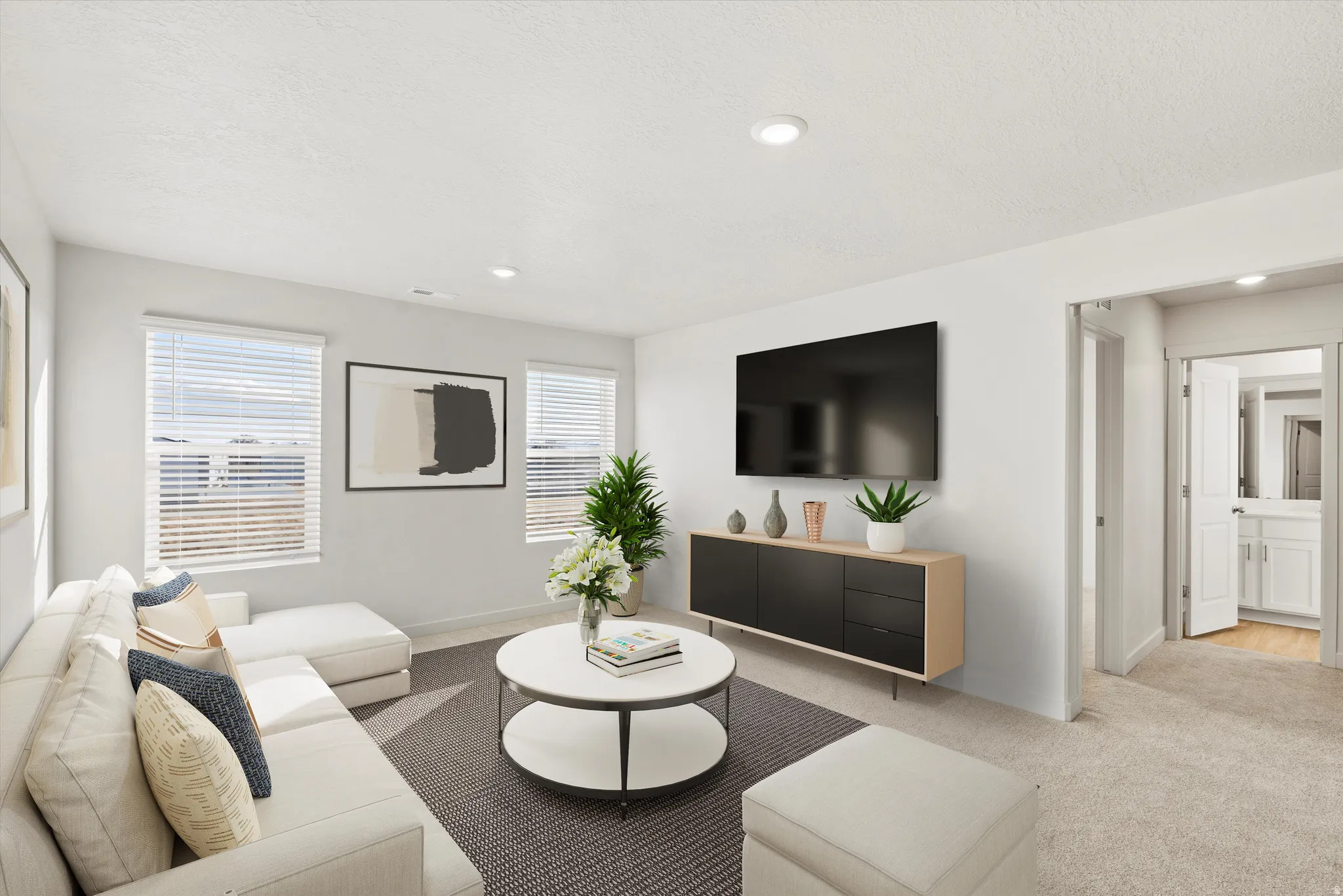Living area featuring light colored carpet, recessed lighting, and a textured ceiling