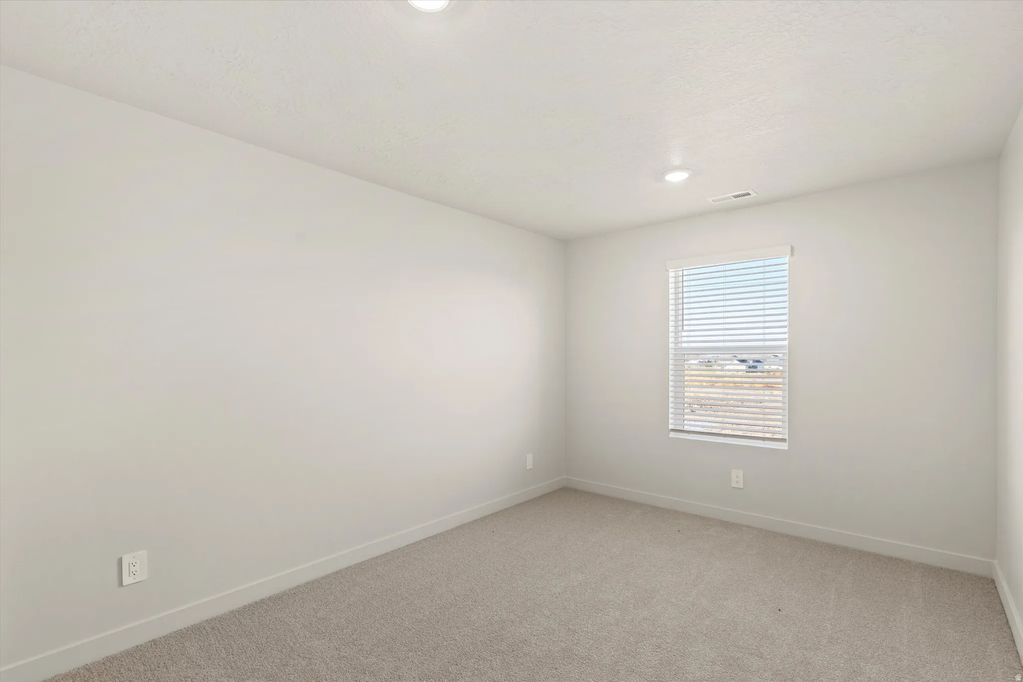 Unfurnished room with light carpet and recessed lighting