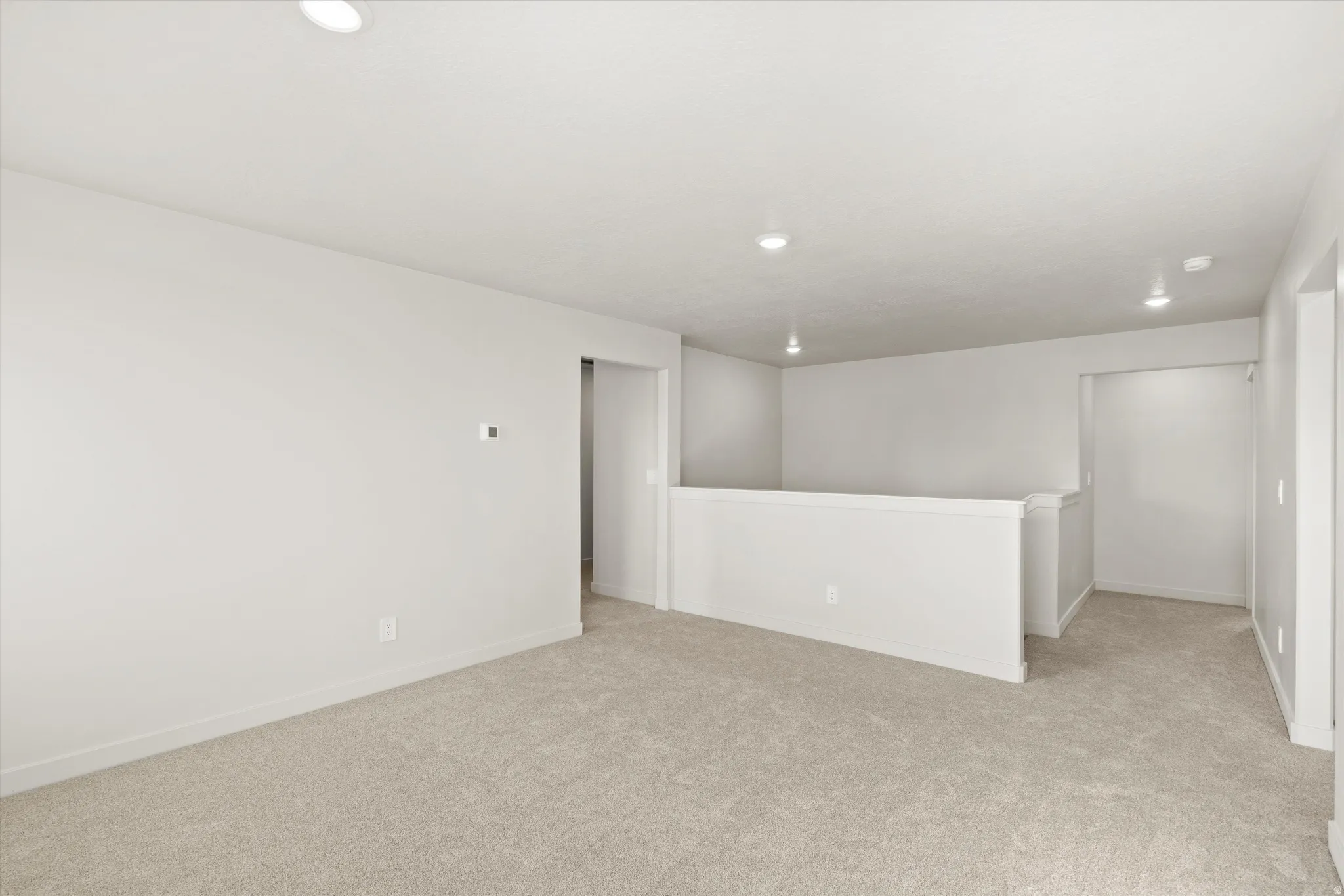 Empty room featuring light carpet and recessed lighting