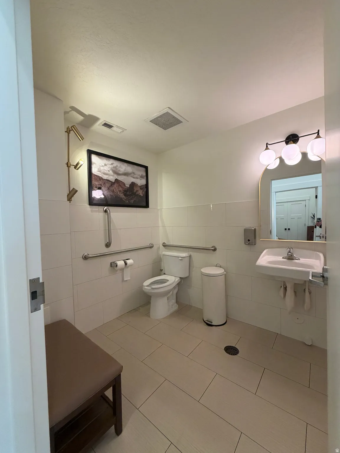 Bathroom with tile walls and light tile patterned floors