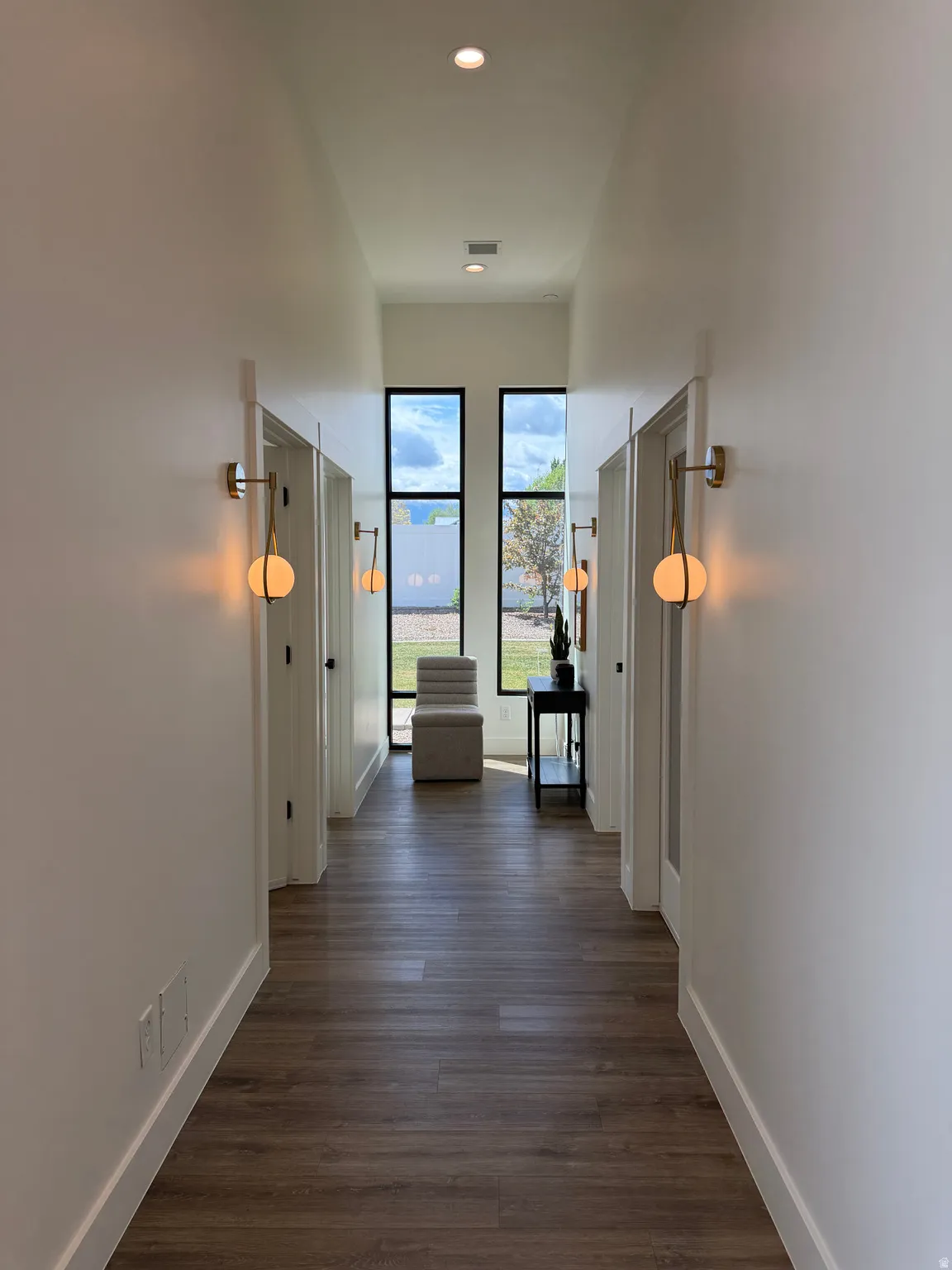 Hall featuring  LVP finished floors and recessed lighting