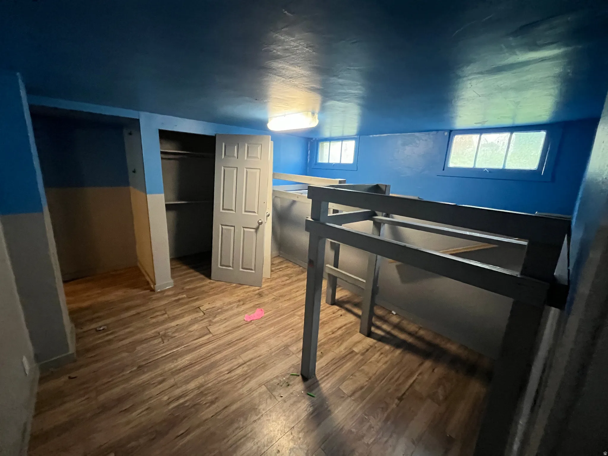 Bedroom featuring wood finished floors and a closet