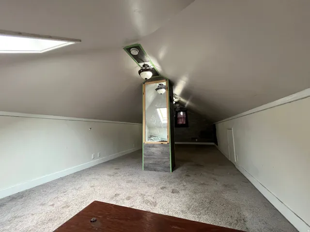 Additional living space featuring carpet floors and baseboards