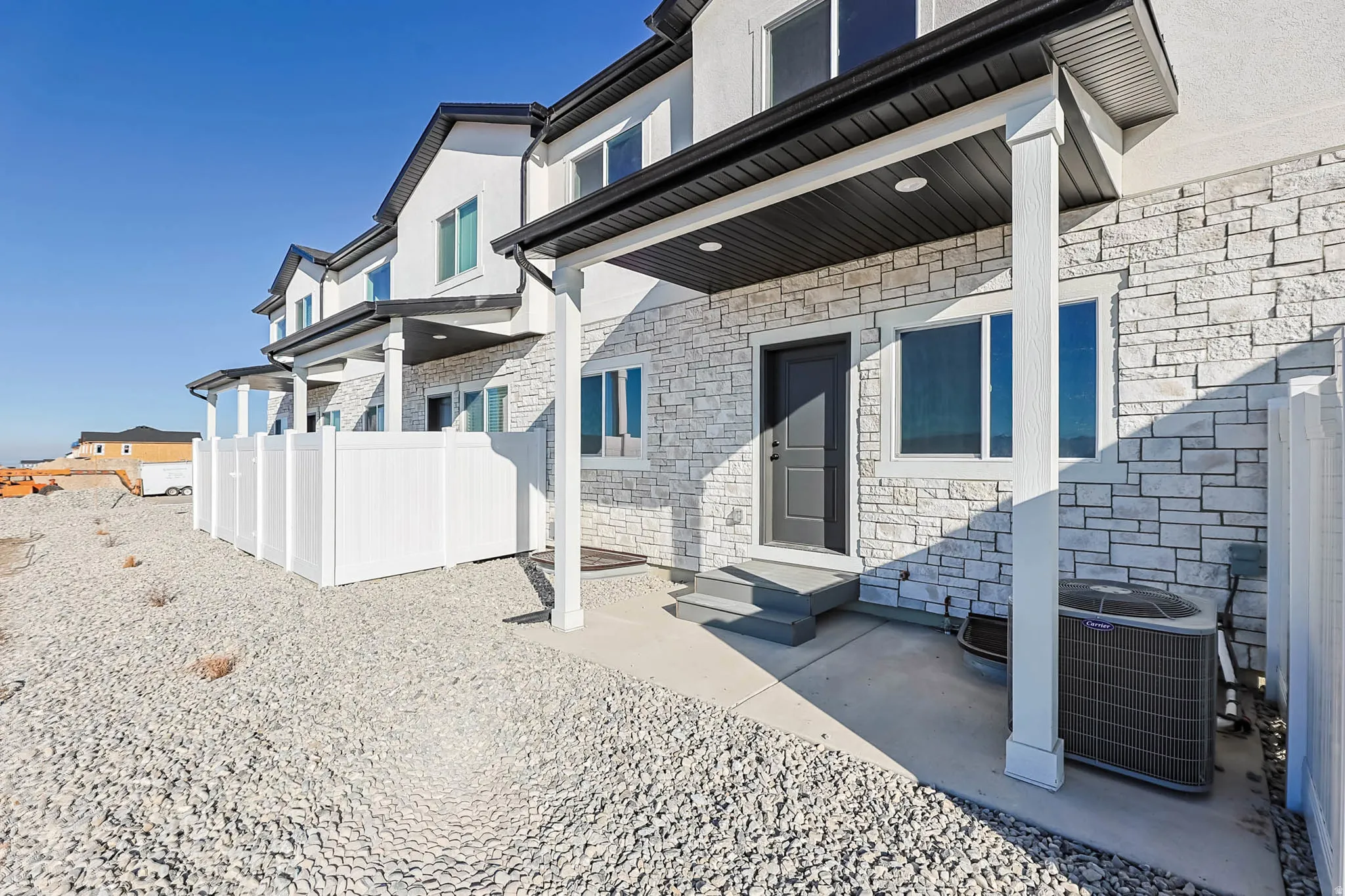 Doorway to property with stone siding and a patio area