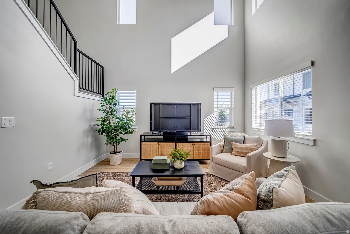 Living room featuring wood finished floors and a high ceiling