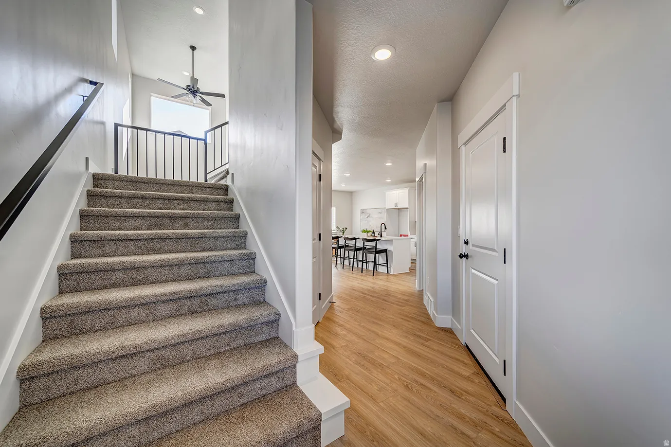 Staircase featuring recessed lighting, wood finished floors, and ceiling fan
