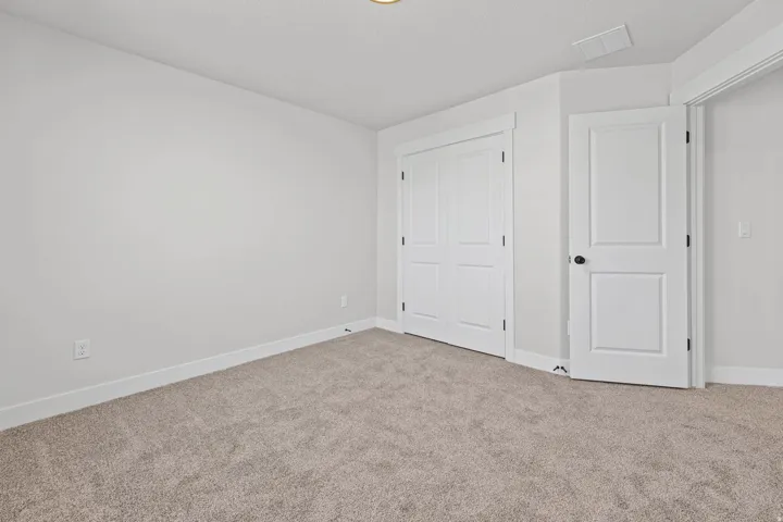 Unfurnished bedroom with carpet and a closet