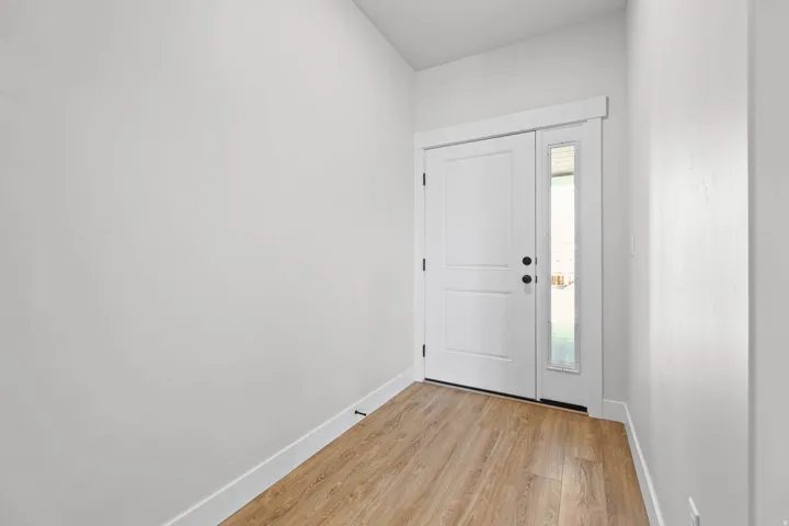 Entrance foyer with baseboards and light wood-style floors