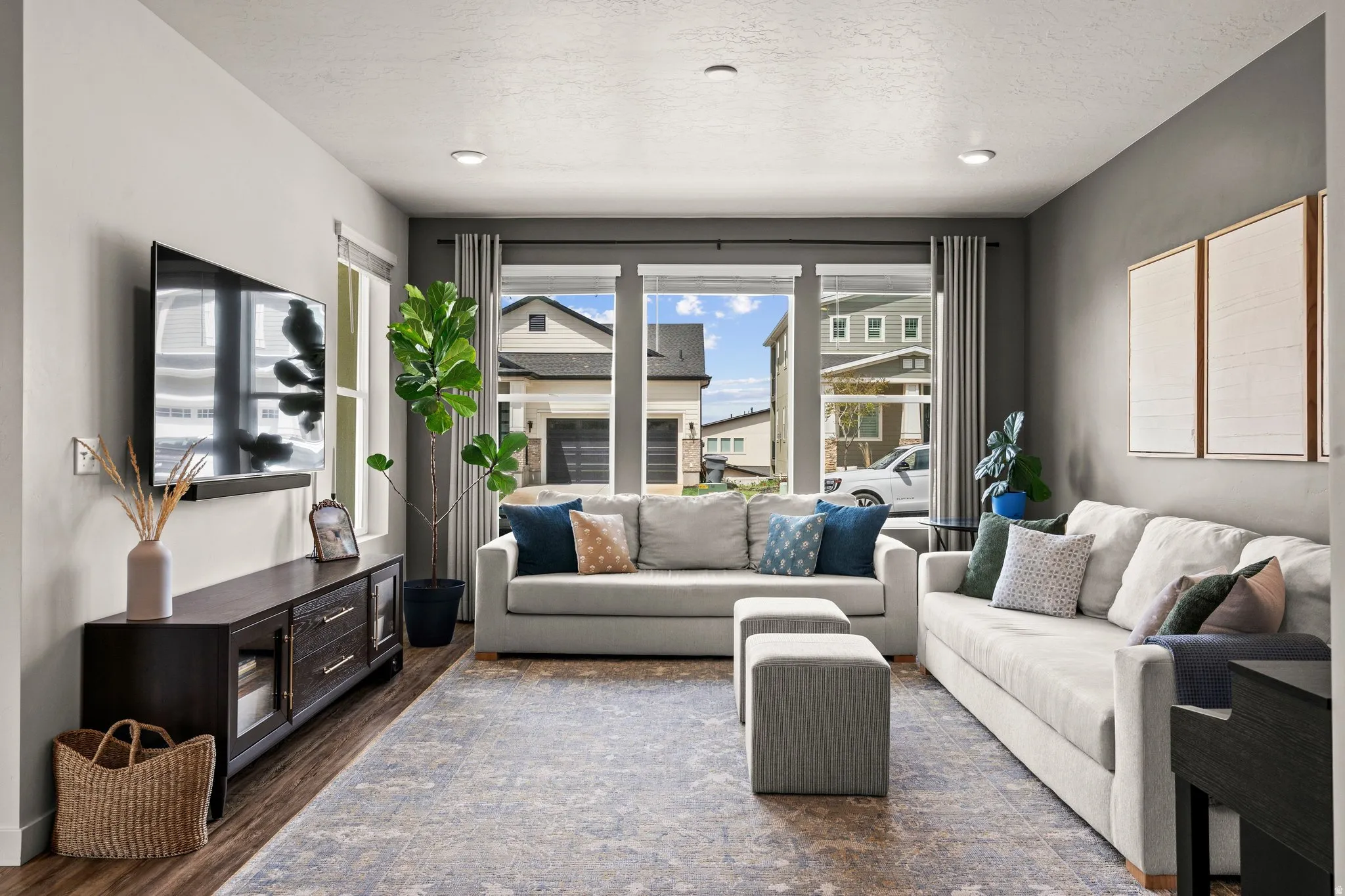 Living room featuring dark wood-style flooring and a textured ceiling