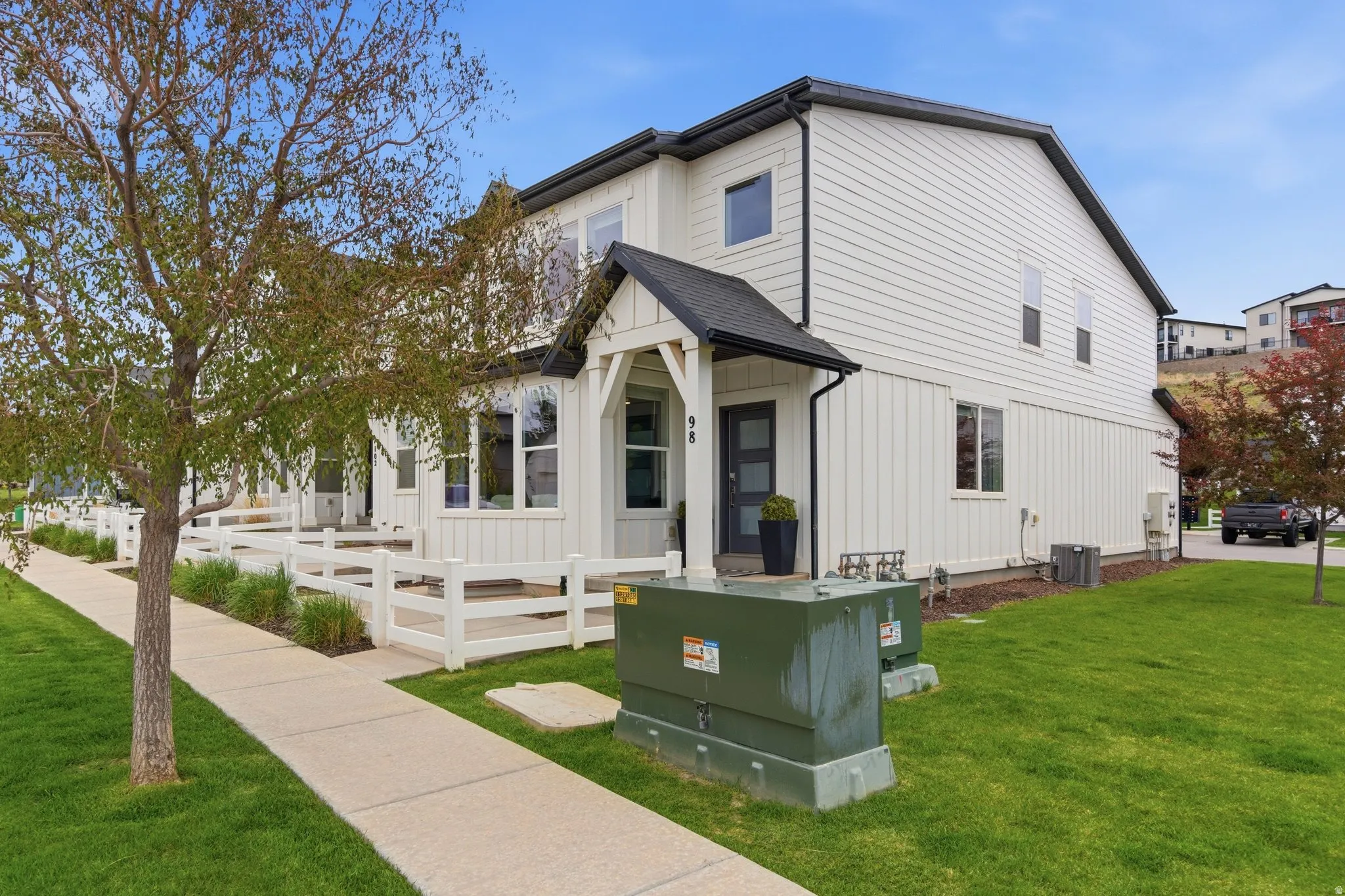 View of front of house featuring a front yard, board and batten siding, and roof with shingles
