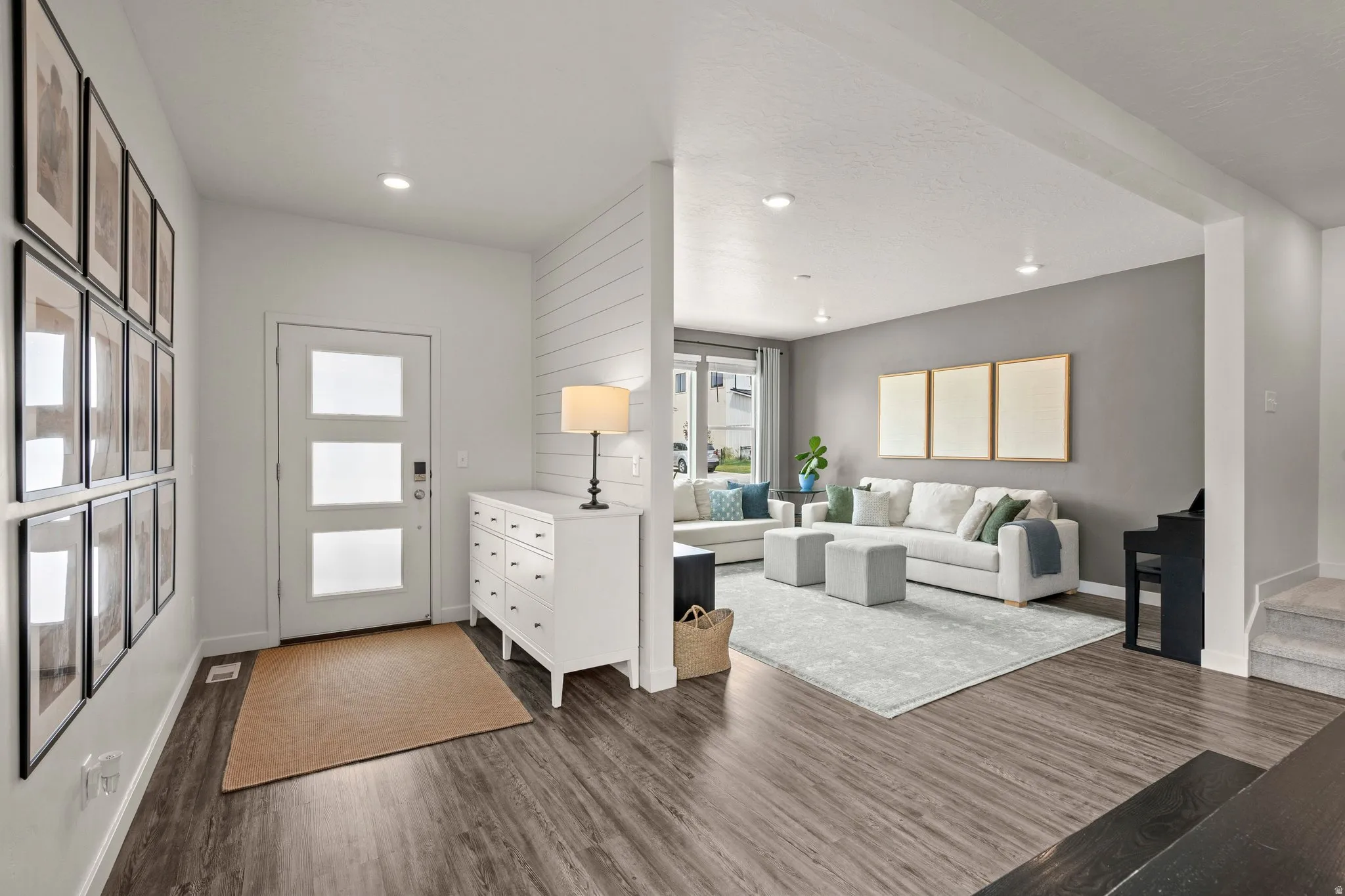 Living room with dark wood-style floors and recessed lighting