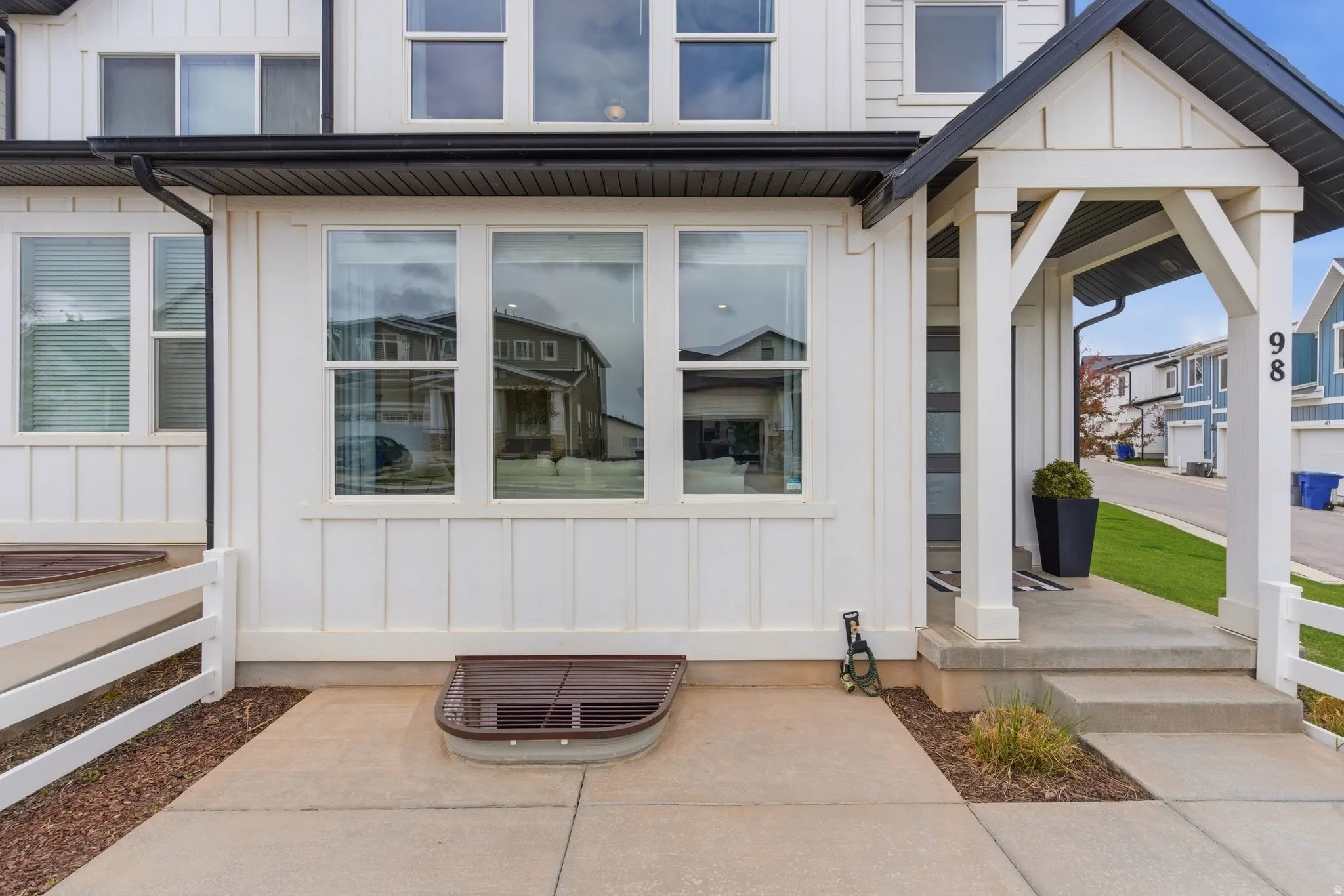 Entrance to property with board and batten siding and covered porch