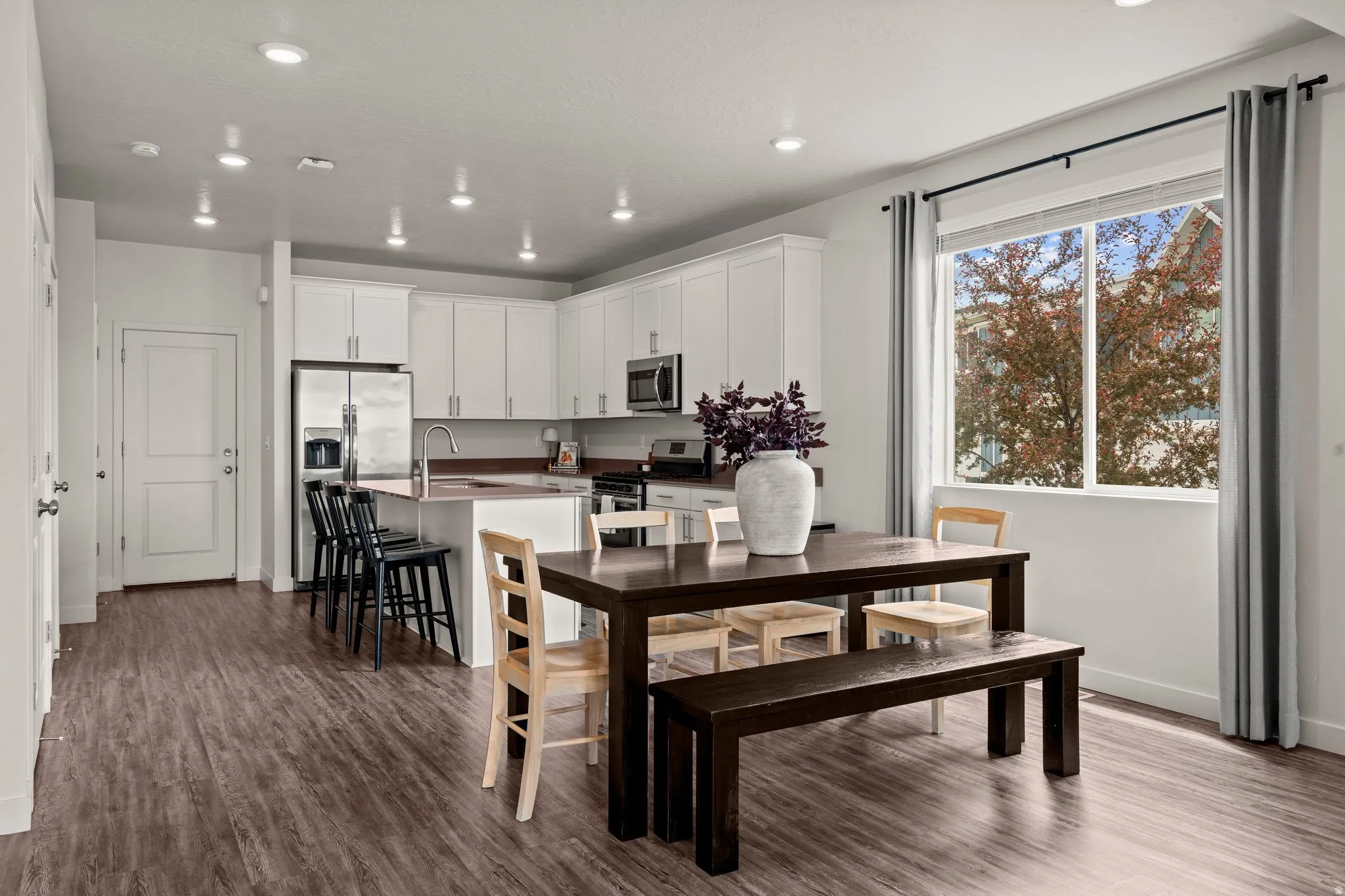 Dining space featuring dark wood-style floors and recessed lighting