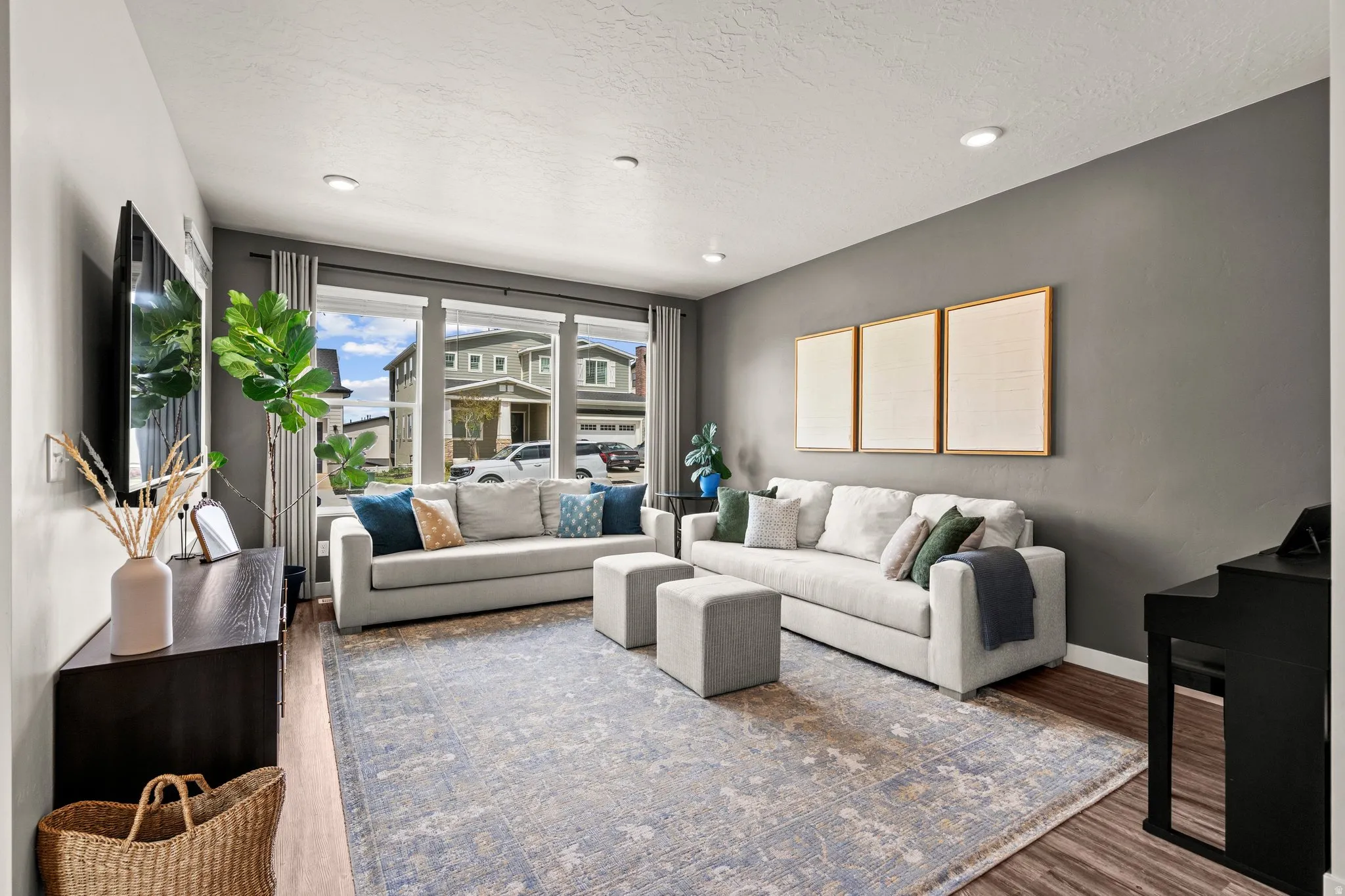 Living area featuring wood finished floors, a textured ceiling, and recessed lighting