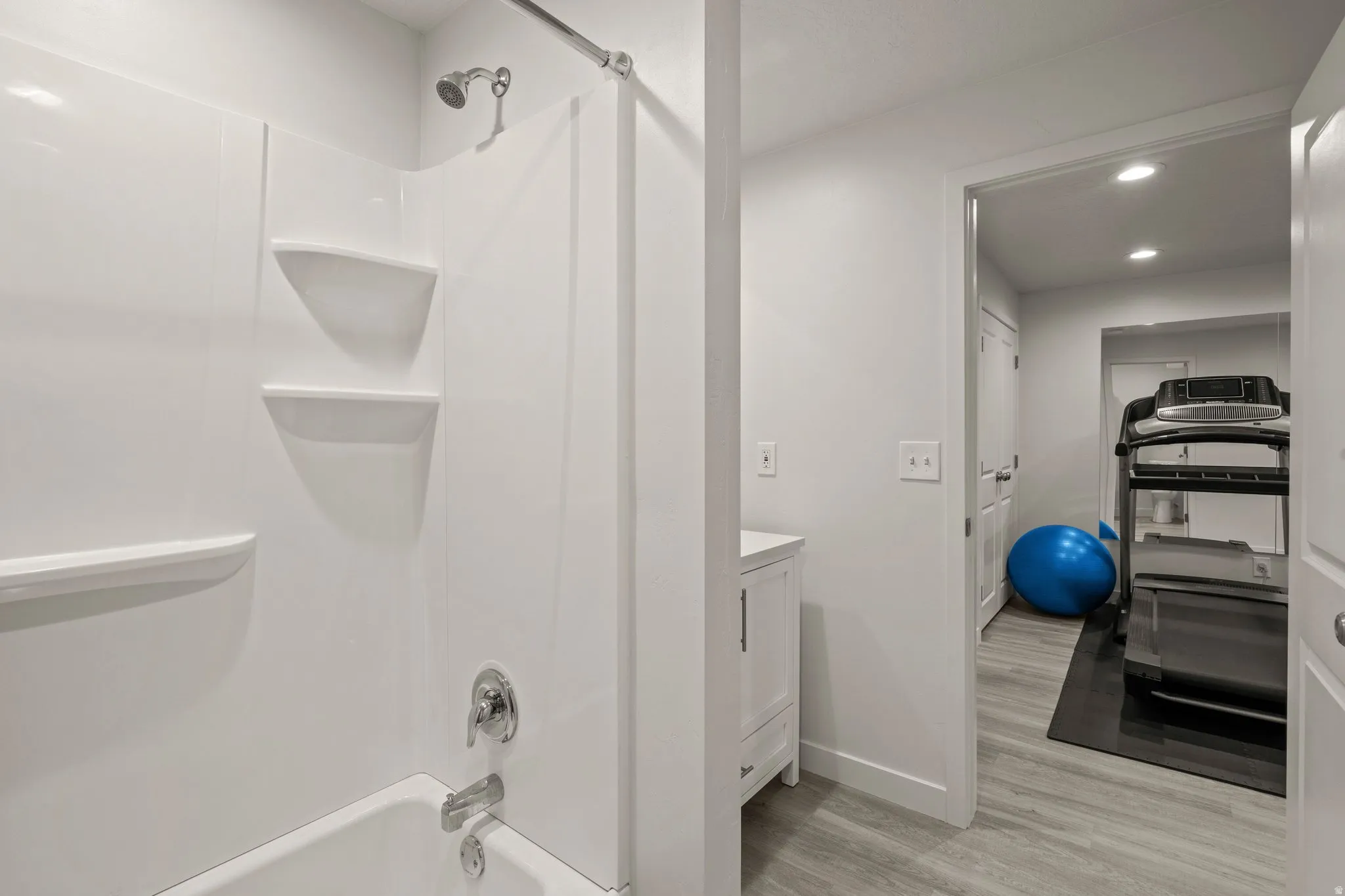 Full bathroom featuring vanity, recessed lighting, light wood finished floors, and bathing tub / shower combination