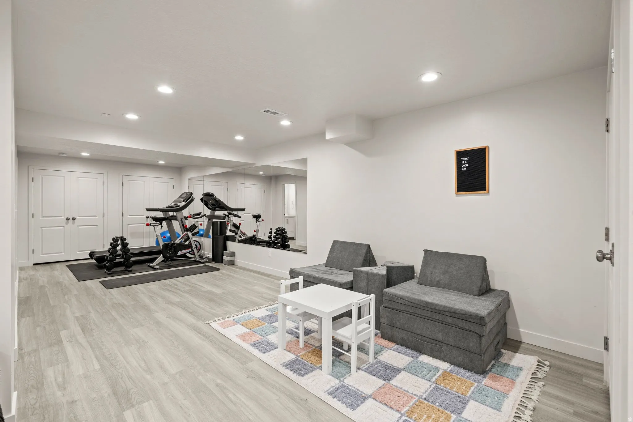 Exercise area featuring light wood-style floors and recessed lighting