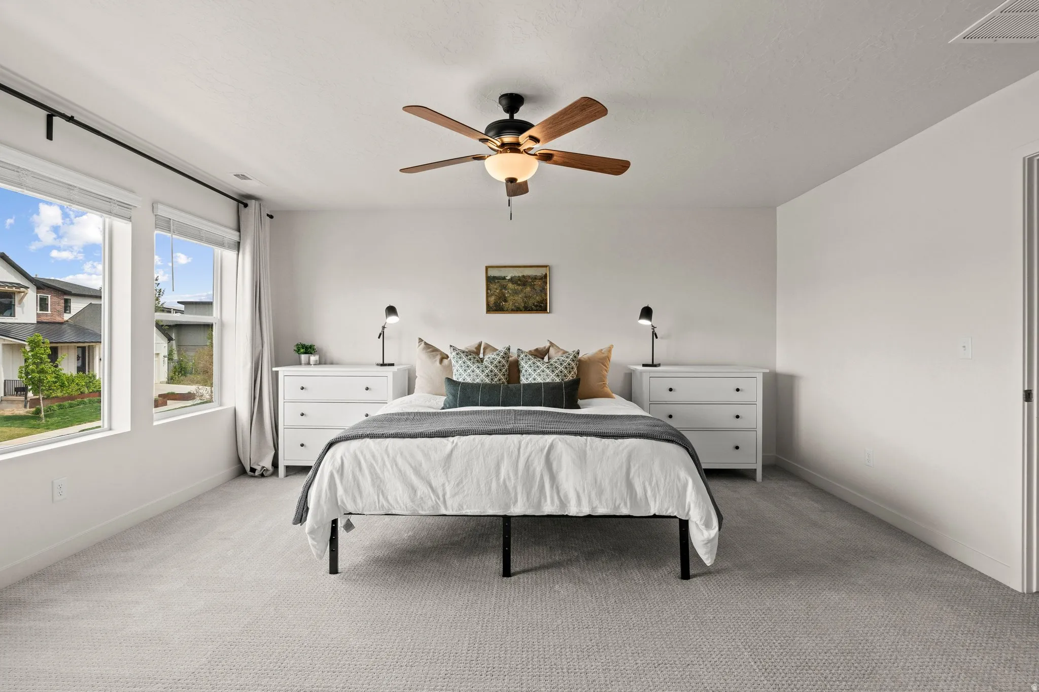 Bedroom featuring light carpet and a ceiling fan