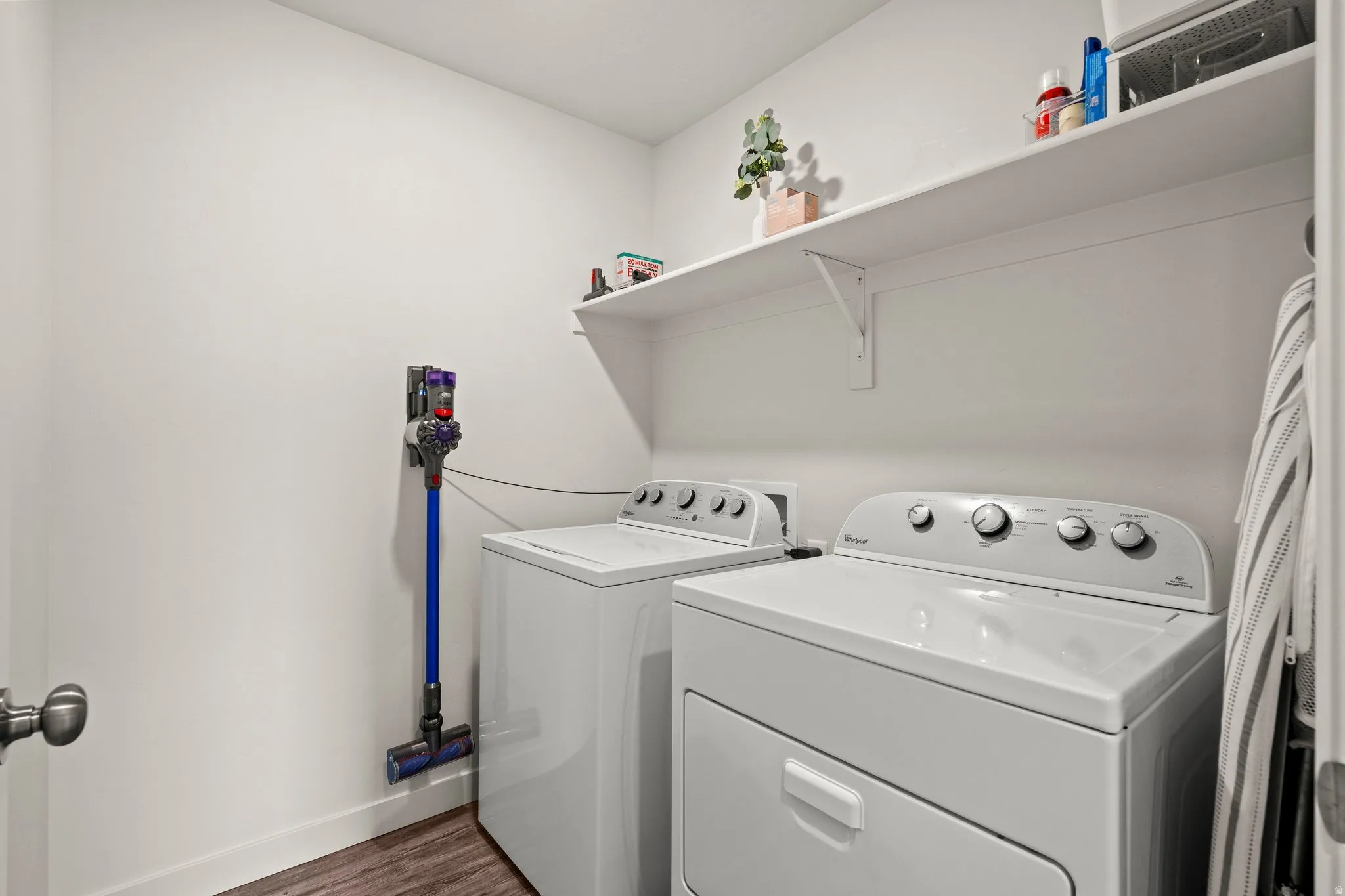 Laundry room featuring dark wood finished floors and separate washer and dryer
