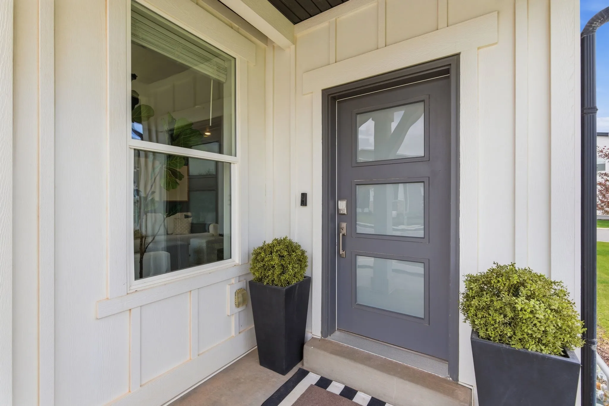 View of exterior entry with board and batten siding