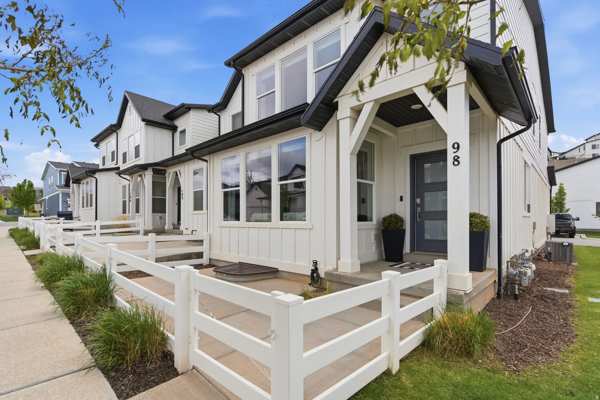 View of front of house with board and batten siding and a fenced front yard