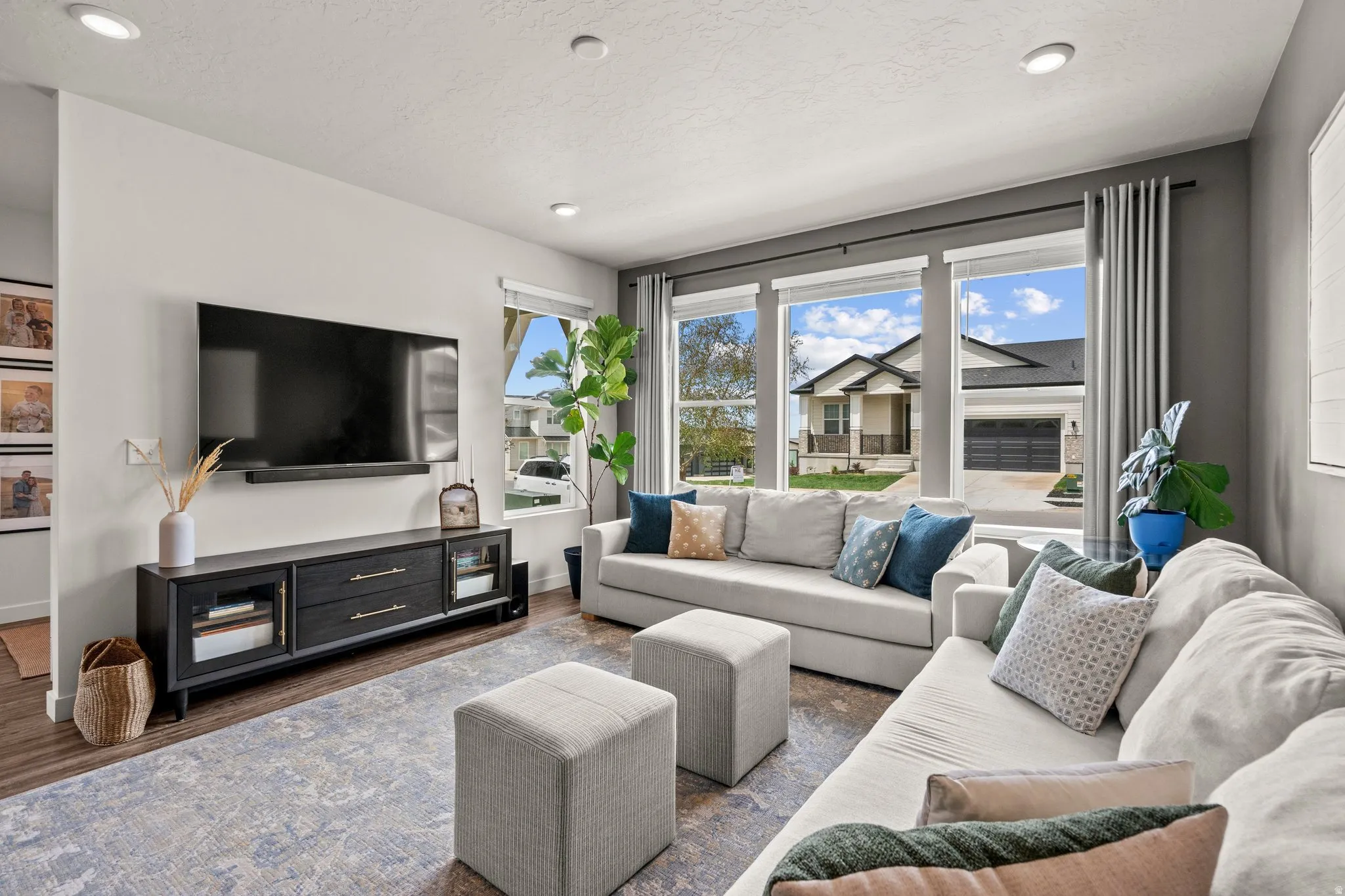 Living area featuring healthy amount of natural light, wood finished floors, and recessed lighting
