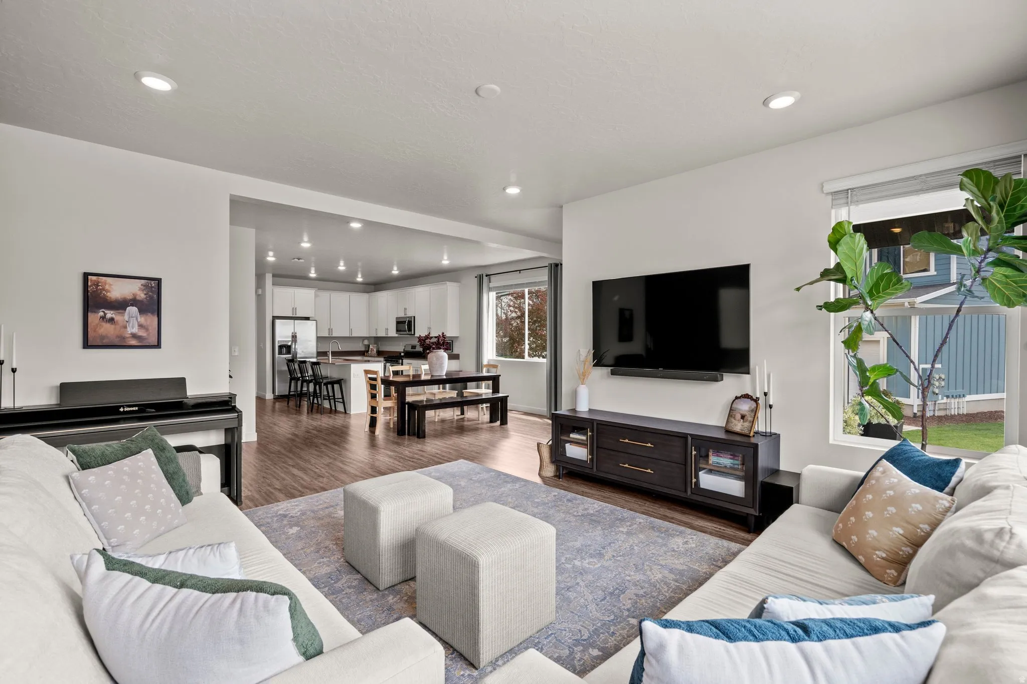 Living area featuring dark wood-type flooring and recessed lighting