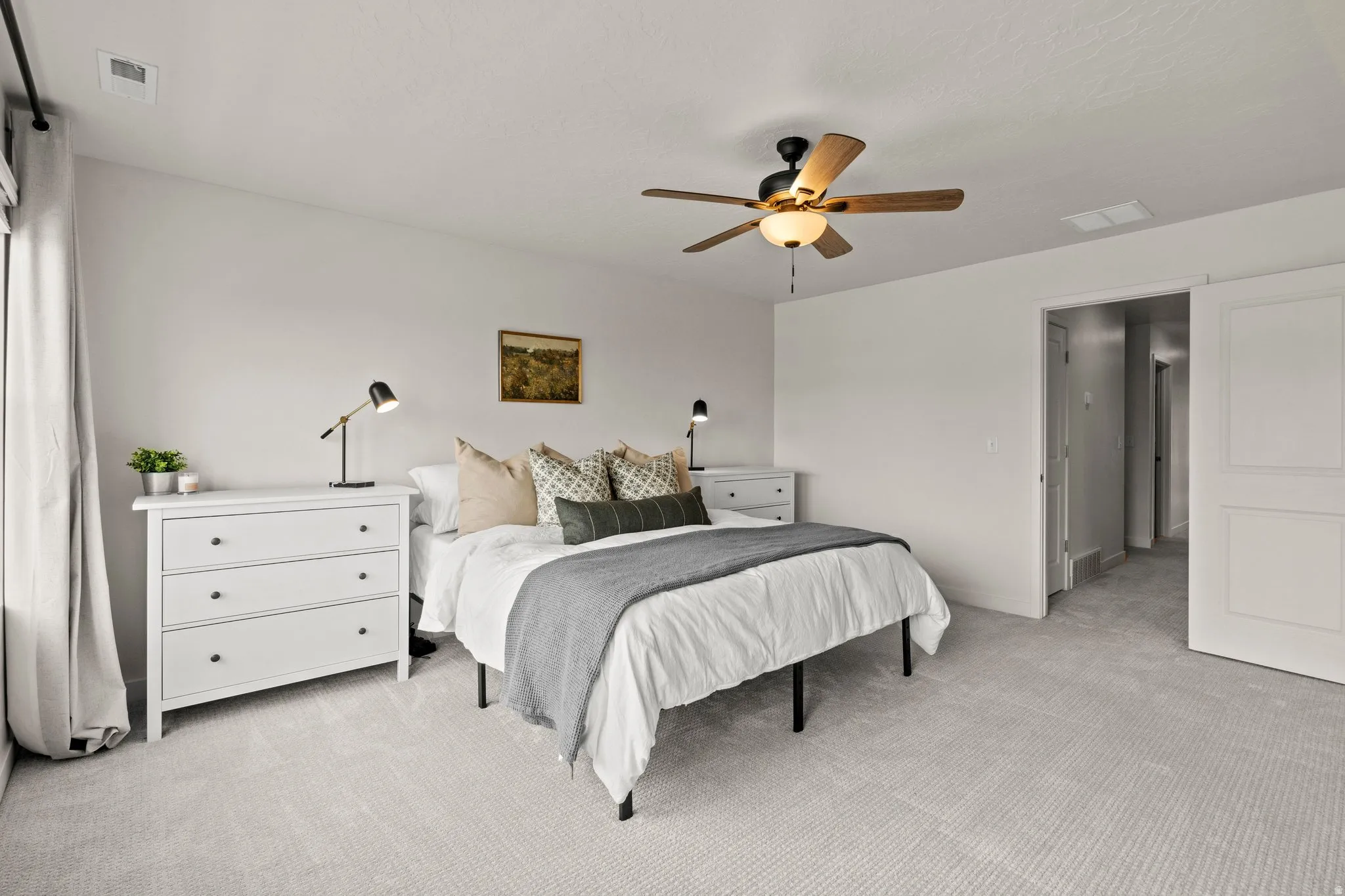 Bedroom featuring light carpet and ceiling fan