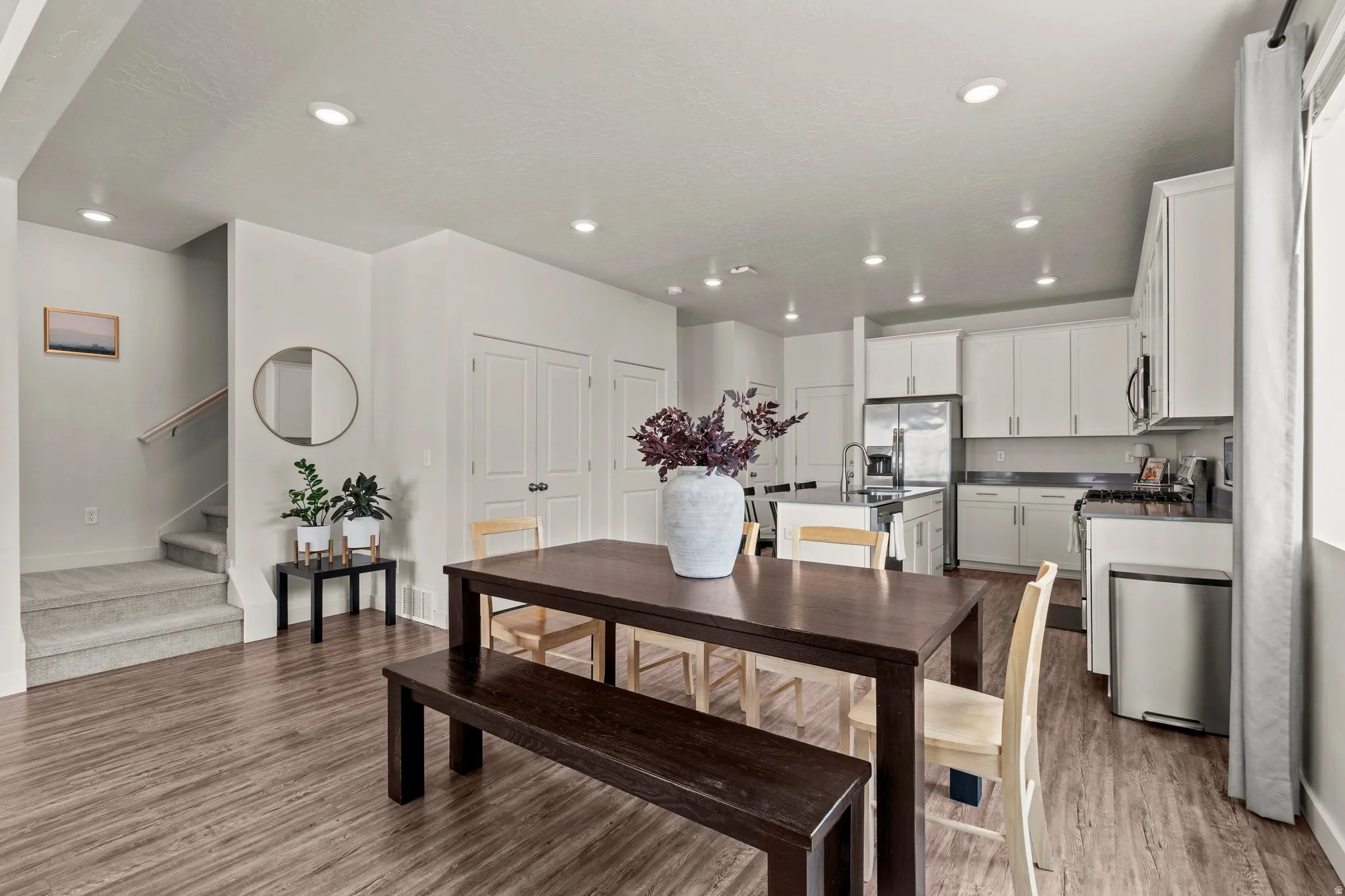 Dining space with light wood-style floors and recessed lighting