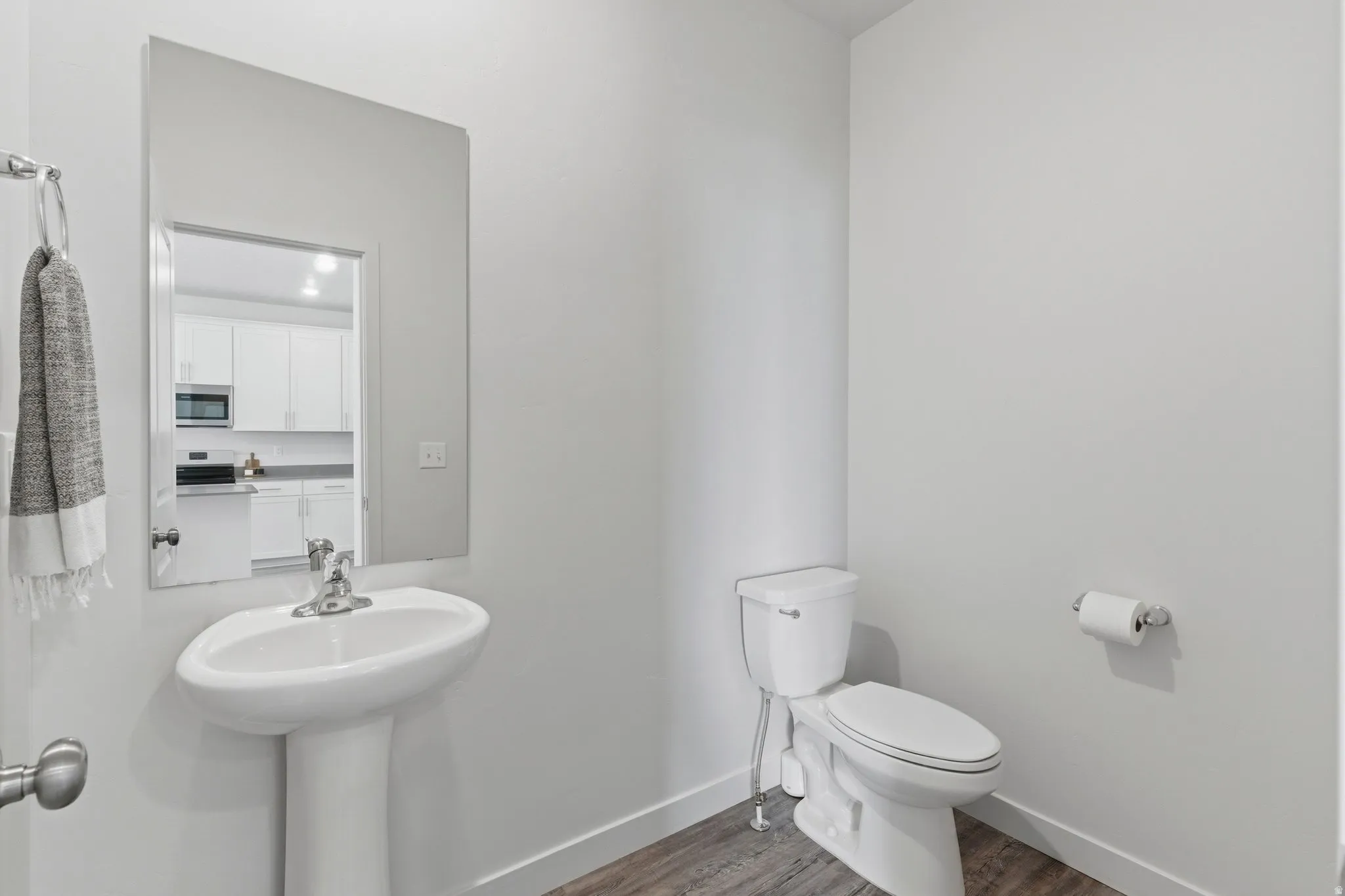 Bathroom with toilet and wood finished floors