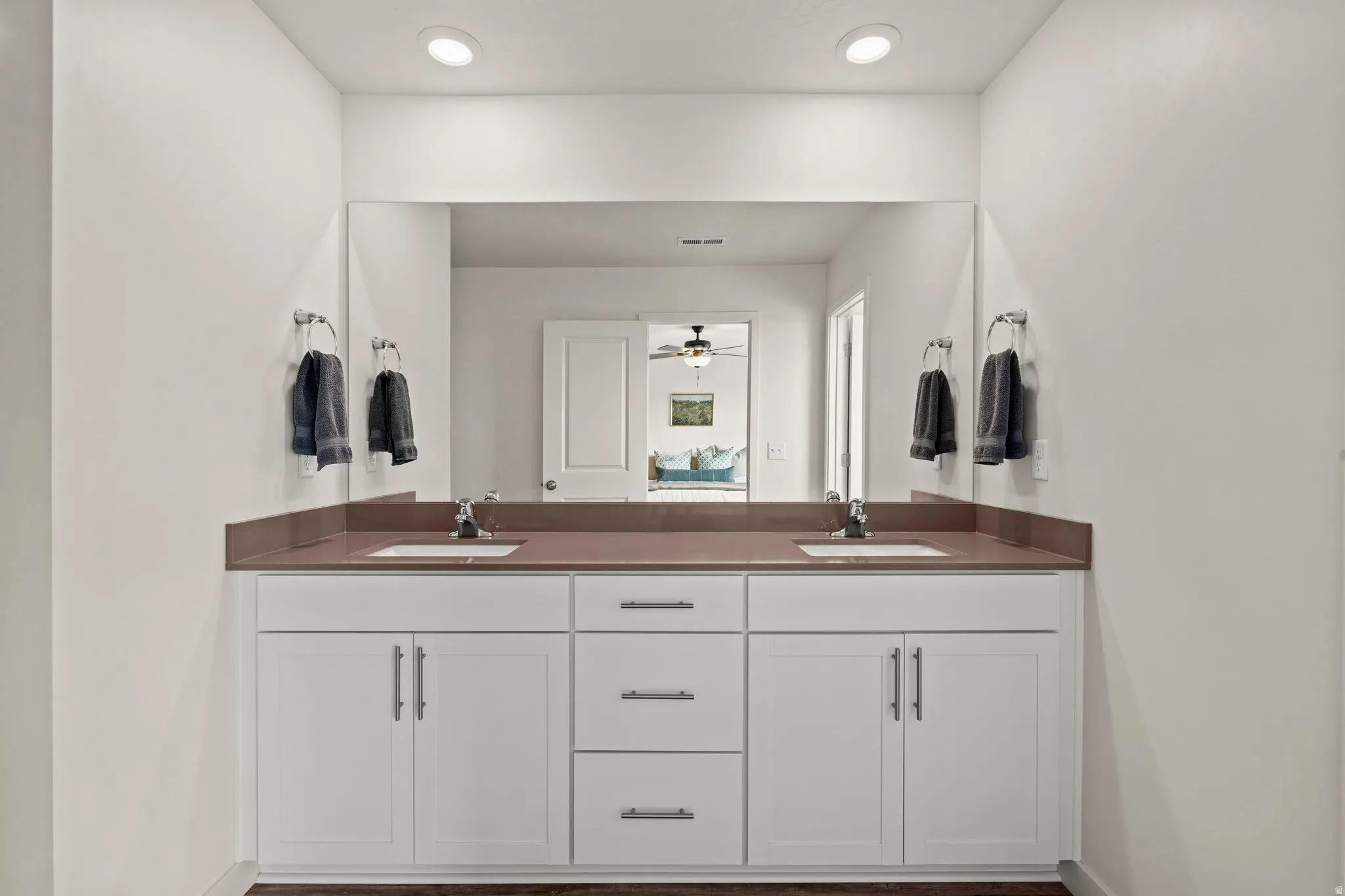 Bathroom with double vanity, recessed lighting, and ceiling fan