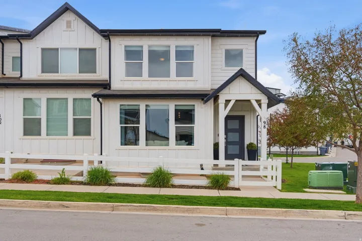 View of front of home with board and batten siding and a fenced front yard