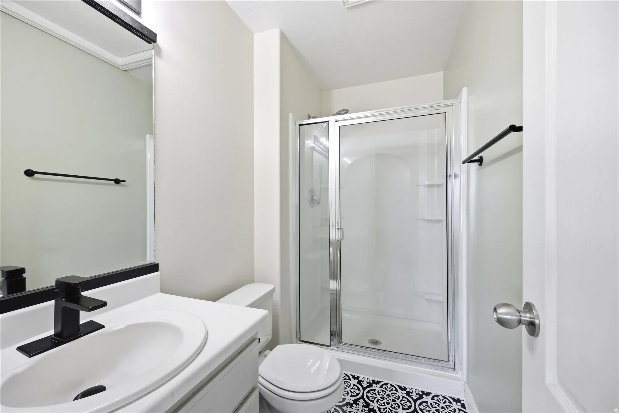 Full bath featuring a shower stall and vanity