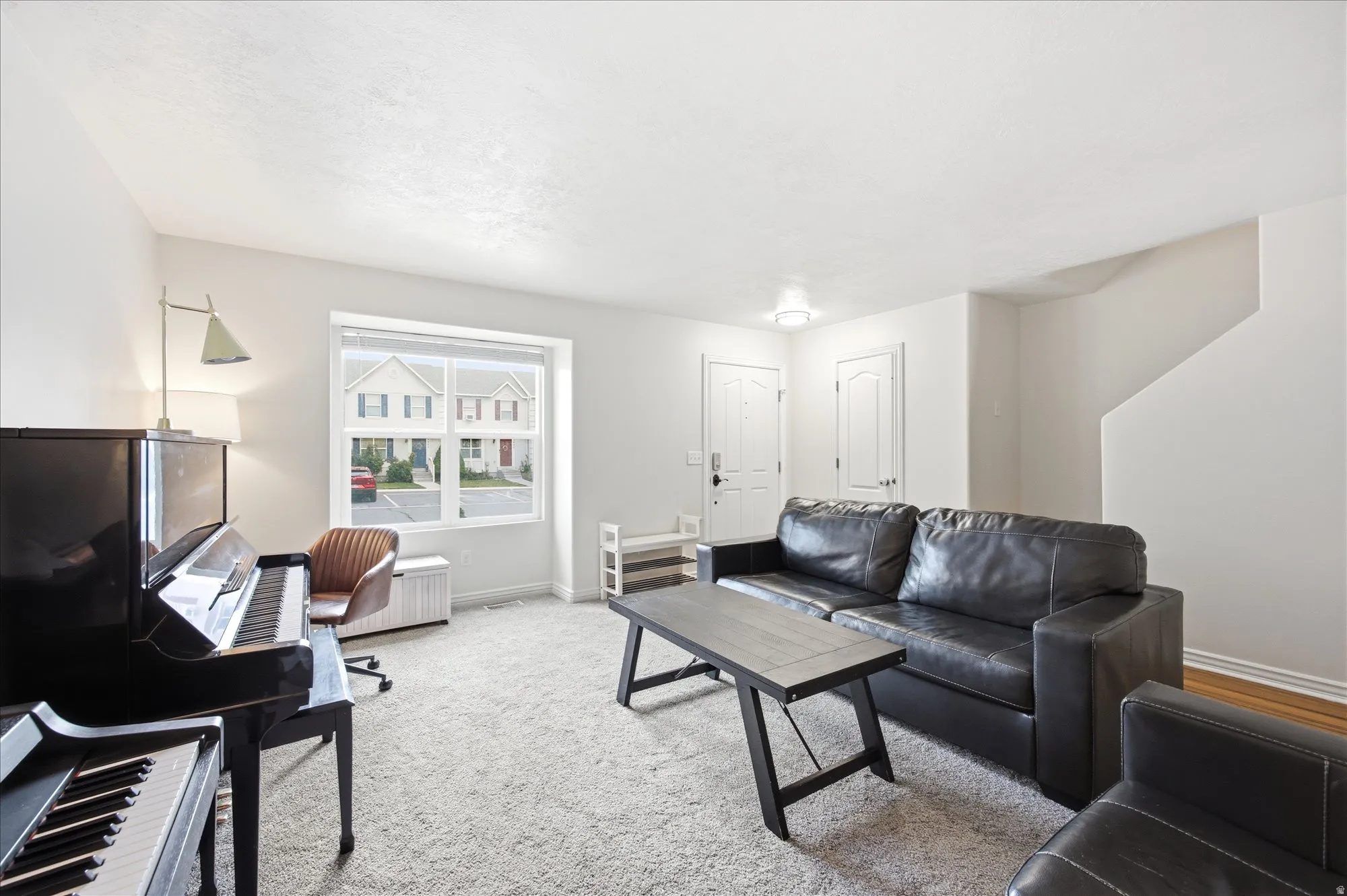 Living room with light carpet and baseboards