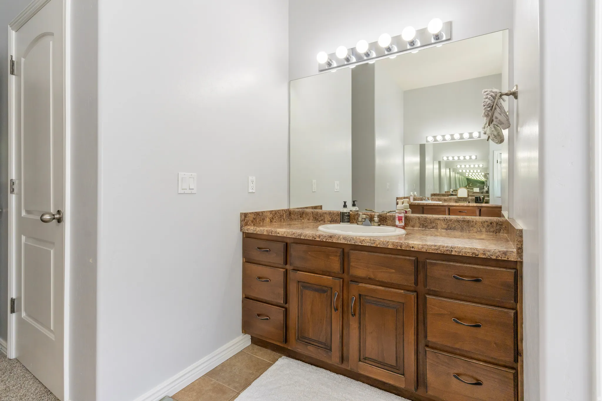 Bathroom featuring vanity and light tile patterned flooring