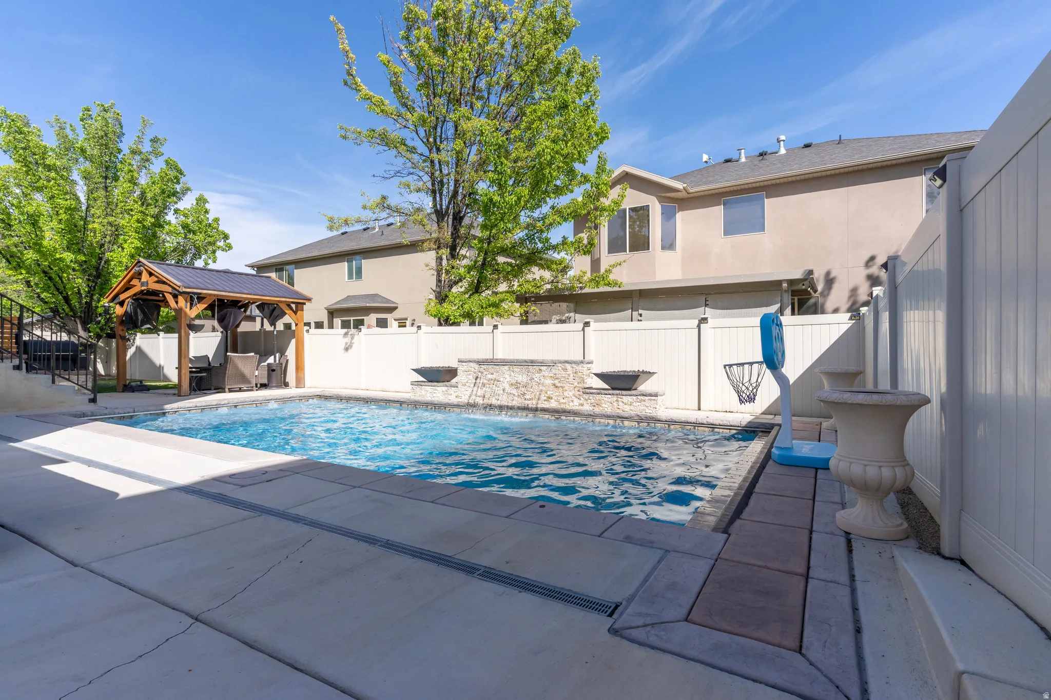 View of swimming pool with patio surround, a gazebo, and a fenced backyard