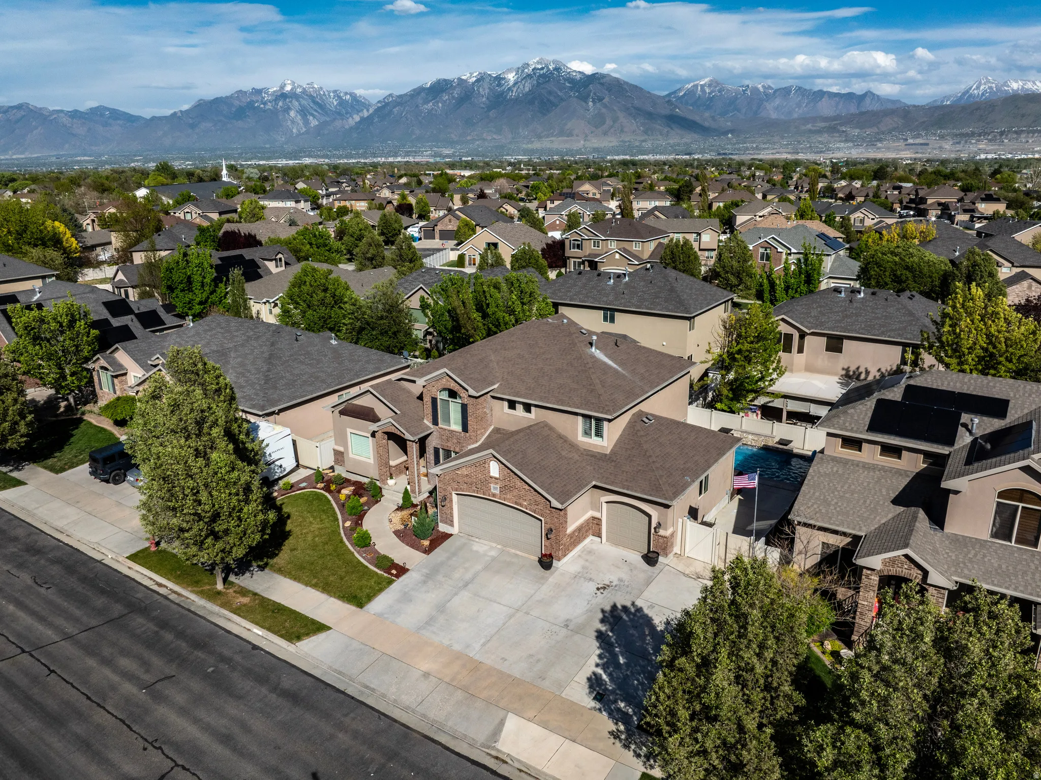 Aerial perspective of suburban area with a mountainous background