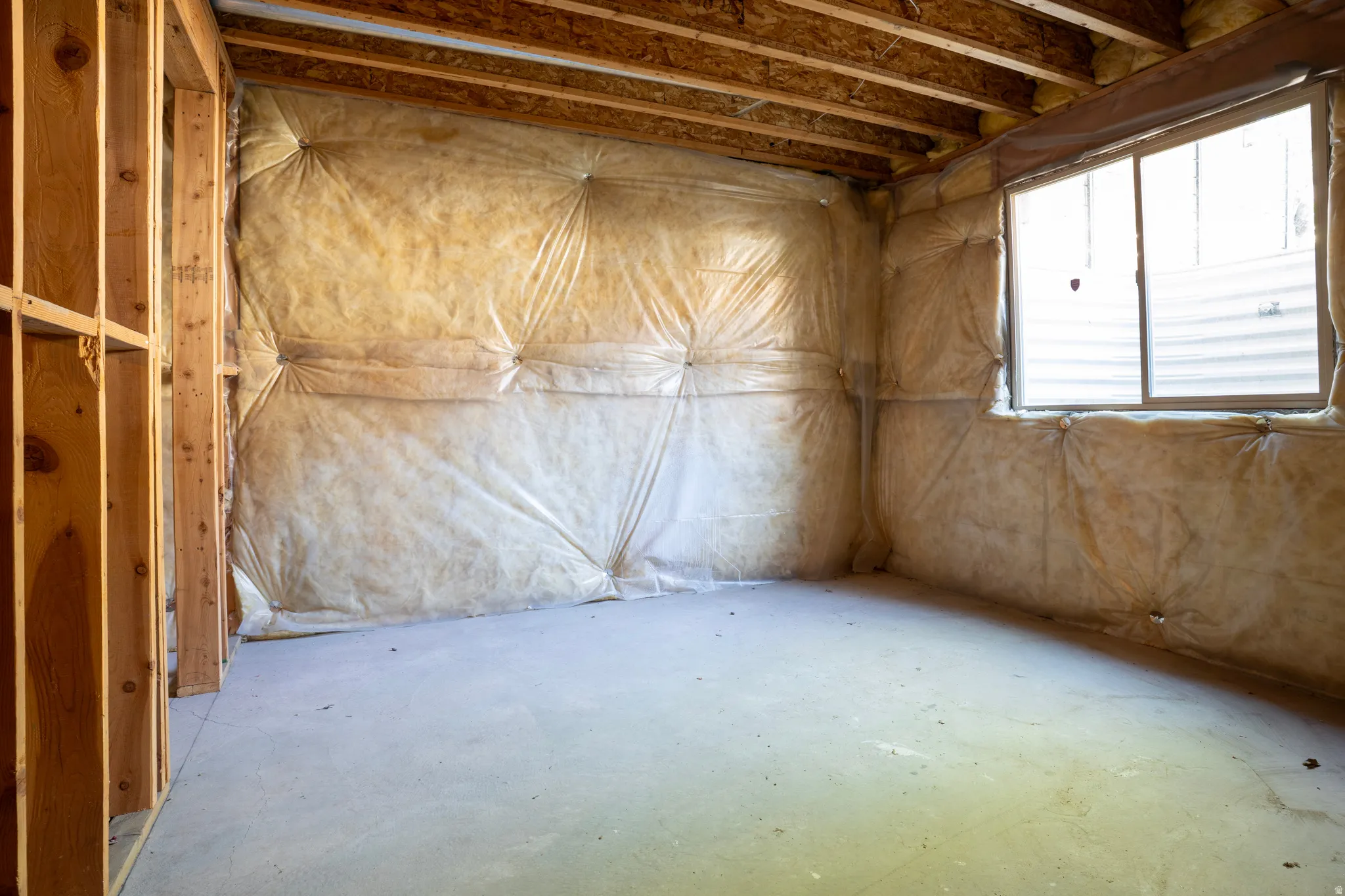 Misc room featuring unfinished concrete flooring